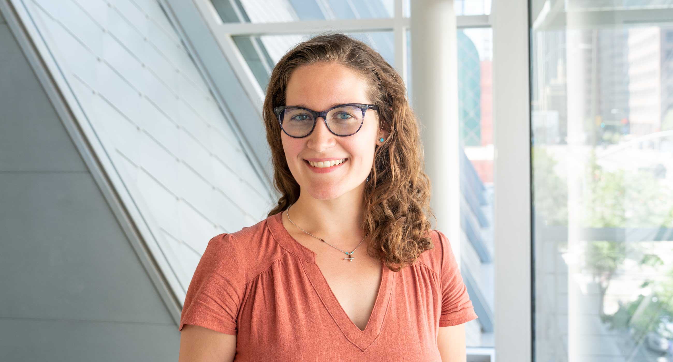 Juliana Bulgarelli smiling in front of a window.