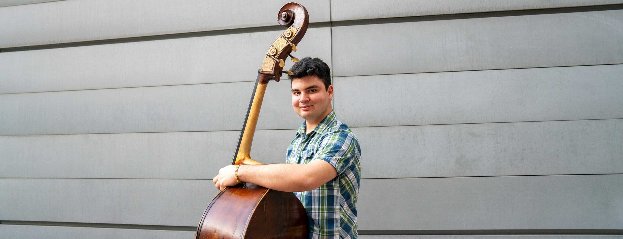 Student posing with double bass
