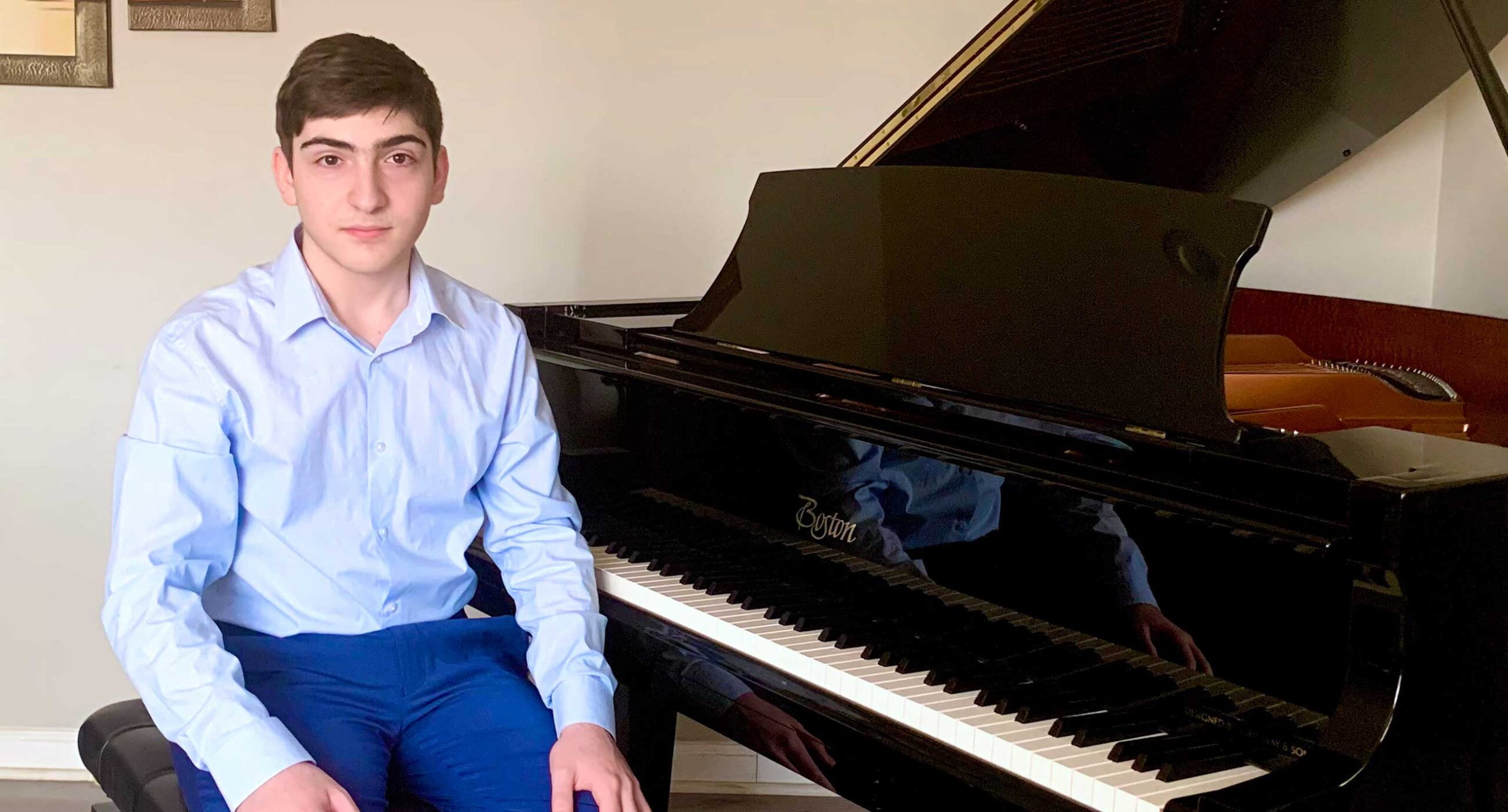Ashot Ter-Martirosyan sitting in front of a piano