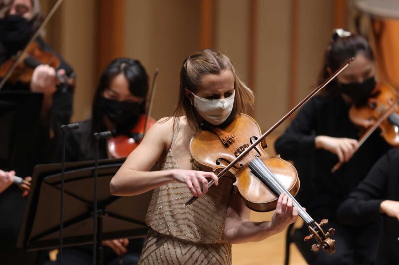 Natalie Loughran plays viola on stage with orchestra
